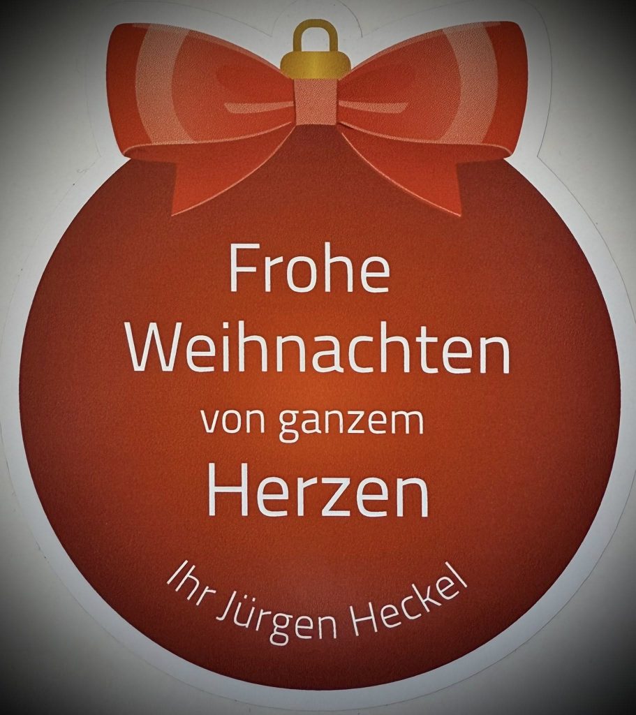 Eine gezeichnete Christbaumkugel in der die Weihnachtswünsche von Jürgen Heckel zu lesen sind